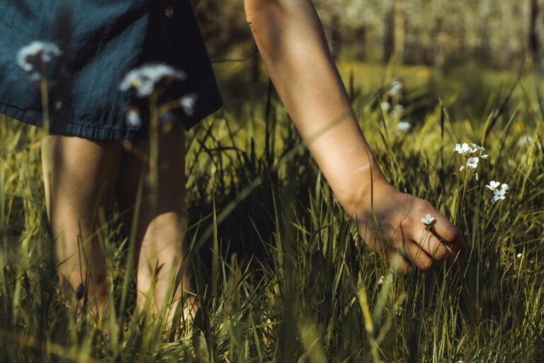 a person's legs and feet in grass