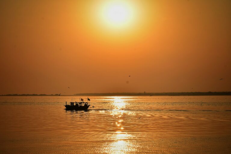 a small boat in the middle of a large body of water
