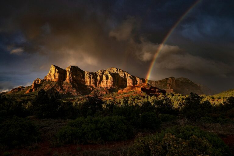 brown rocky mountain under gray sky